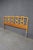 French Provincial king-size headboard featuring a gracefully shaped silhouette with repeating openwork scroll and ring...