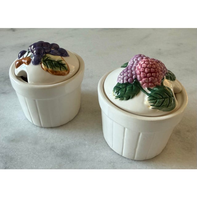 Pair of charming vintage ceramic jam pots featuring hand painted and embossed fruit lids with detailed berry and grape...