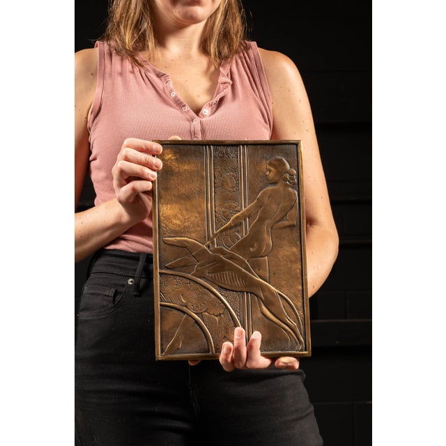 c. 1930s; The Merit Co., Chicago Low relief bronze casting depicting a nude woman walking two leashed greyhounds. It...