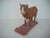 Hide is made of felt; this cow pull toy rides on a salmon stained wheeled cart and possess an air bellow ( in working...