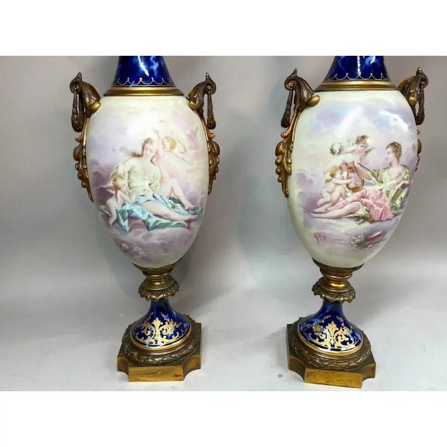 This stunning pair of mid-19th-century French Sevres porcelain vases is a true testament to the grandeur and refinement of...