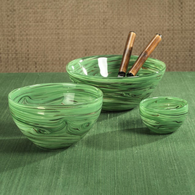The Delphine Glass Serving Bowl showcases a stunning blend of color with its vibrant swirl design that covers the entire...