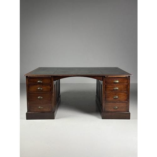 A beautiful english desk/partner desk. Originating in england, mid-20th century. Top inlaid with green leather. Minor wear...