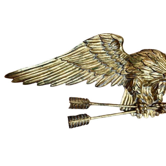 On offer is a hand-carved wooden wall hanging of an eagle. The symbolism of the eagle with spread wings, clutching the two...