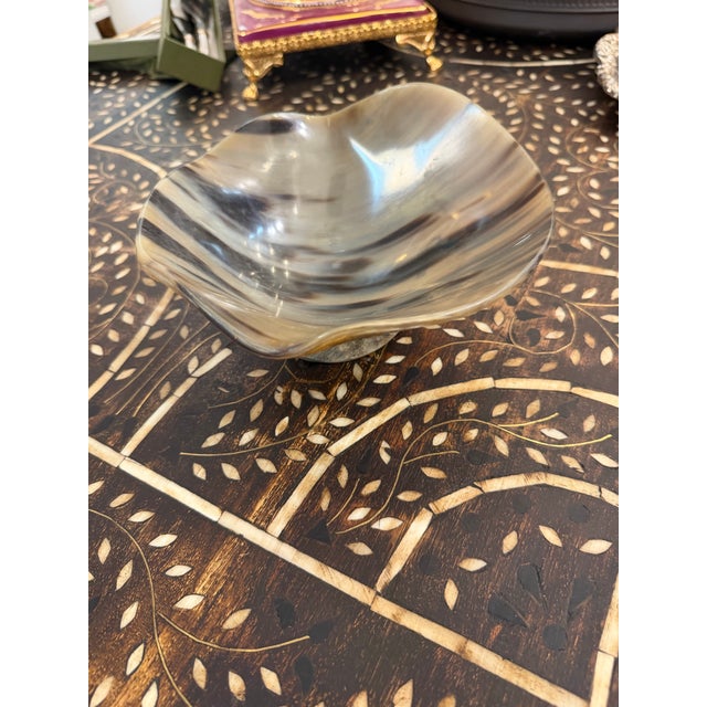 Polished horn scallop rim decorative bowl. Carved by hand and mounted onto a matching base.