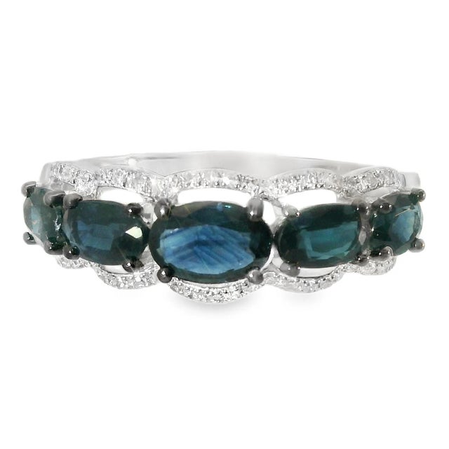 This 14K White Gold Graduated Sapphire Diamond Band Ring radiates timeless elegance and charm. The ring showcases 50...