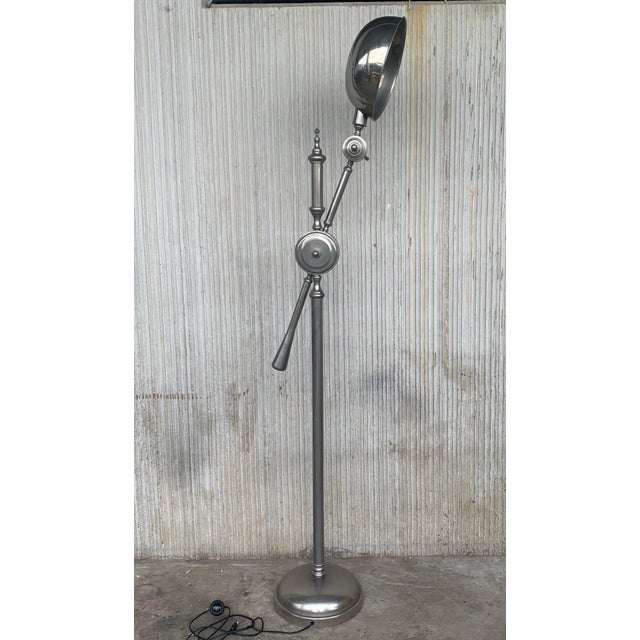 A substantial midcentury industrial lamp. An incredible piece with solid cast iron base, long chrome arm and fittings with...