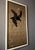 A striking vintage hand-embroidered silk panel depicting two black birds in flight against an intricately woven gold...