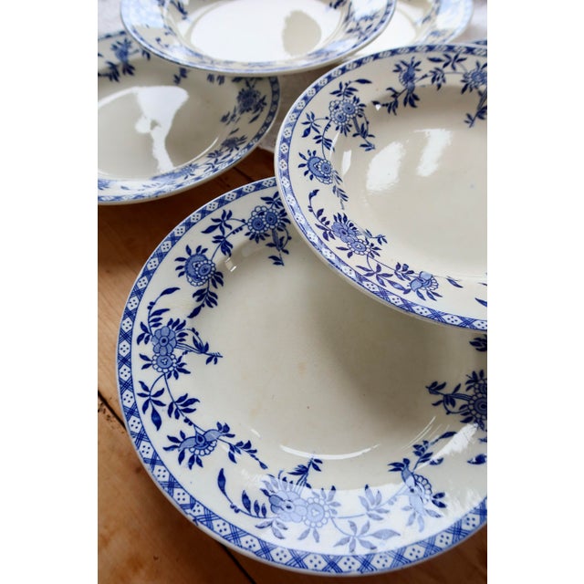 Set of six antique Dresden porcelain soup plates, decorated with an elegant cobalt blue floral design and a geometric...