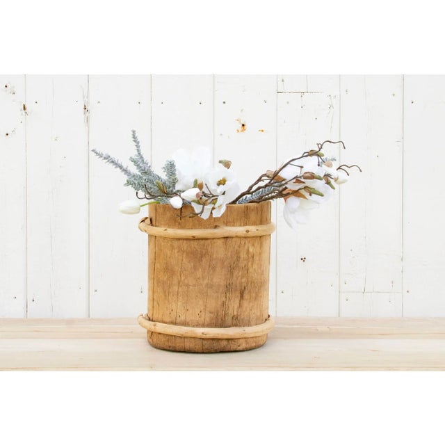 A vintage wood and bamboo container with a tall round shape. This Asian water bucket has a clean bleached finish with...
