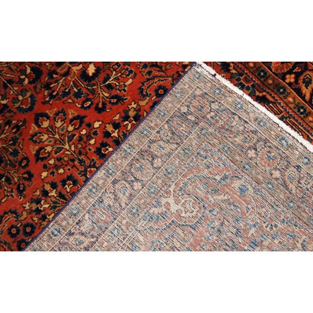 Hand made antique Persian Sarouk rug in red wool. The rug is in original good condition from the beginning of 20th...