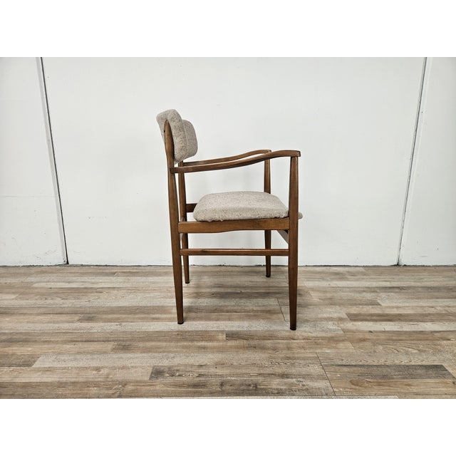 An elegant Scandinavian armchair, characterized by organic lines and harmonious proportions that express all the...