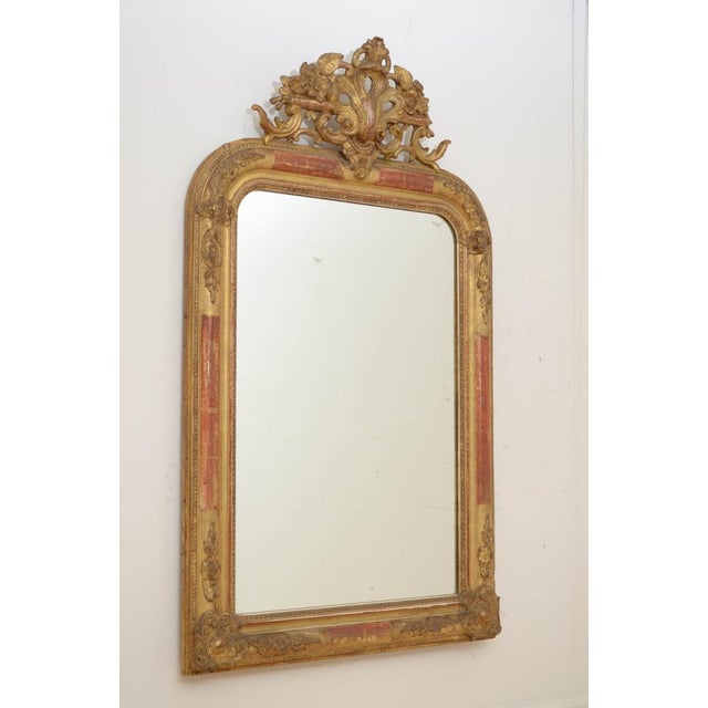 Fine XXth century French giltwood wall mirror in gilded and moulded gesso frame with decorative floral corners to the top...