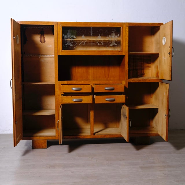 Beautiful sideboard, Italian design and production from the 1950s. Comprising compartments with doors, drawers, and an...
