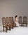 This set of six early 20th century Renaissance oak dining chairs from France, made in dark oak with tall slatted backs and...
