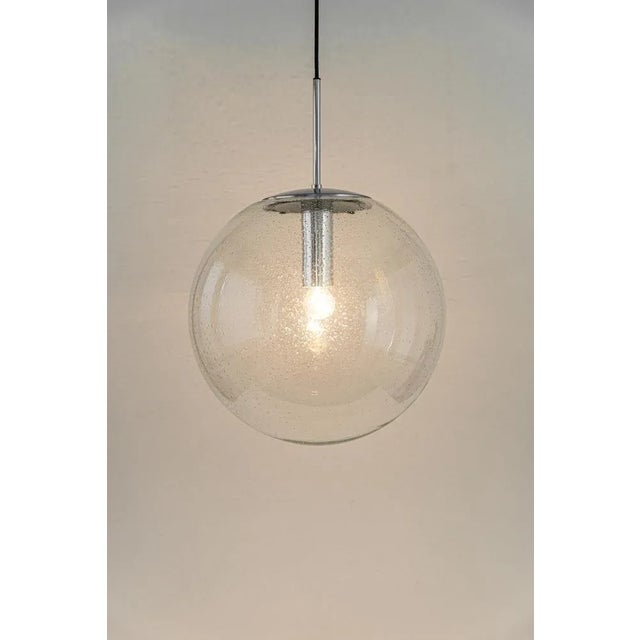 1 of 2 large glass ball pendants, manufactured by limburg, germany, circa 1970-1979. Sockets: one x e27 standard bulb...