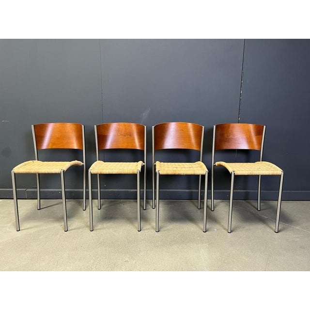 Elegant wicker and chrome dining chairs with a nice wooden backrest. Tilmeless design made in Italy by Porro. Very goo...