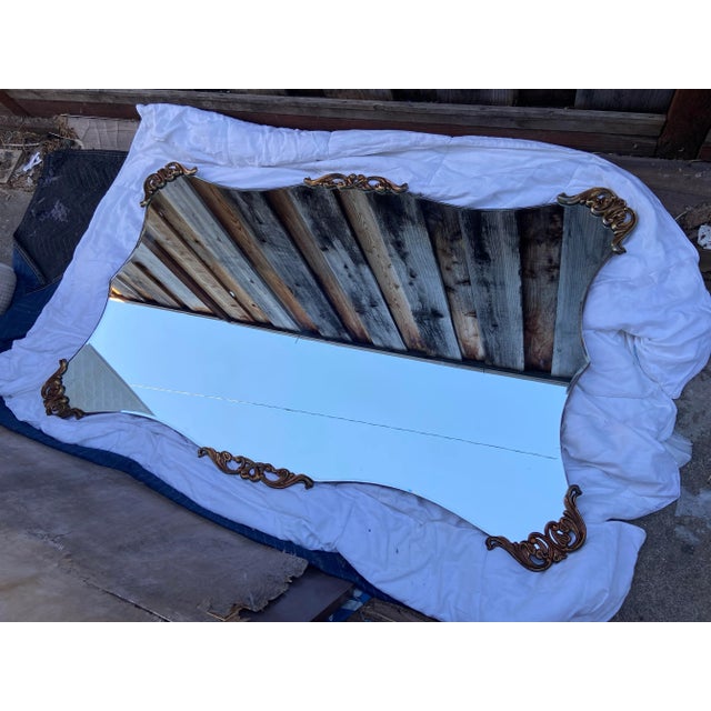 This vintage large 40s gold Rococo Hollywood Regency mirror exudes a classic and timeless style that is perfect for any...