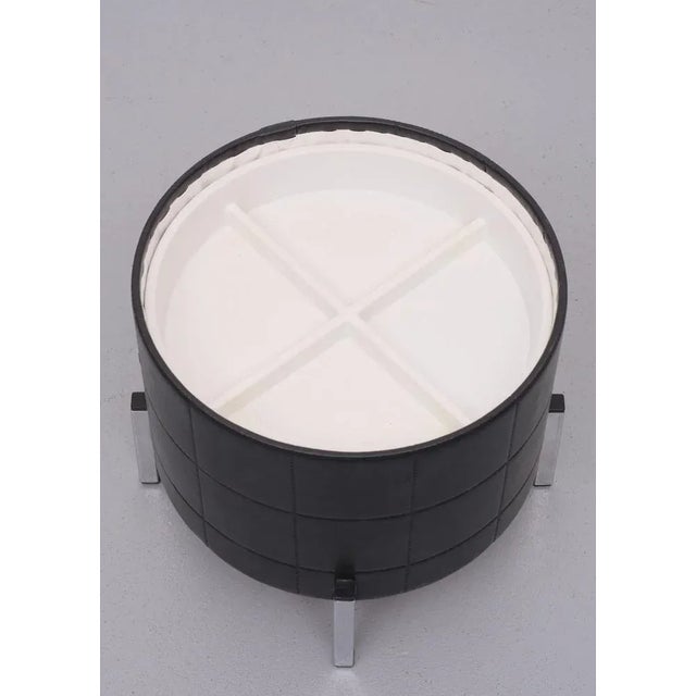 Typical 1960s,This round sewing box, black faux leather upholstery. Chrome square legs. inside a pull out tray. And more...