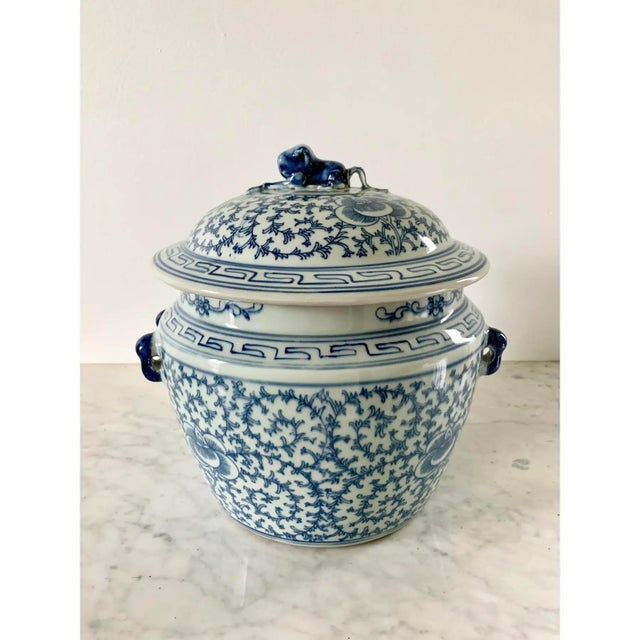 A stunning pair of blue & white porcelain Chinoiserie covered jars with foo dog finials China, 20th century Measures:...