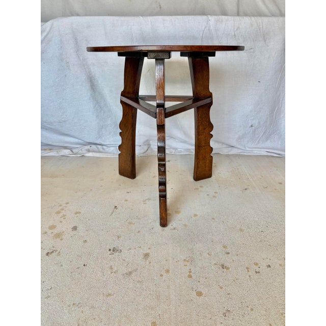 This 20th Century English Oak Tavern Cricket Table dates back to the early 1900's. The piece features a round plank top...