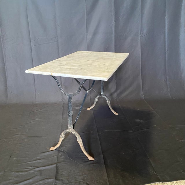 Classic and versatile French marble top gray cafe table or writing desk with a classic Provincial iron base. Marble is a...