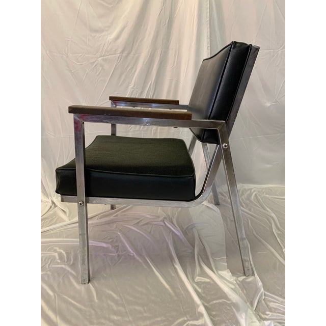This vintage chrome and black upholstered Eck-Adams chair is a great piece of modern functional furniture that will add a...
