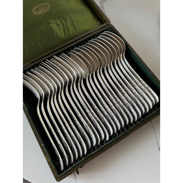 A complete set with its original box of antique Christofle flatware set from its timeless " Canaux Laurier " pattern from...