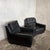 A matching pair of Art Deco club armchairs with broad sculptural arms, deep buttoned seats and individually upholstered...