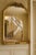 Bring timeless European elegance to an interior with this ornate gilt wall mirror, distinguished by its graceful arched...