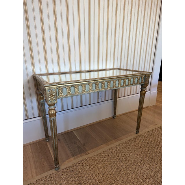 Elevate your interior with the refined elegance of this antique Italian Neoclassical giltwood console table, topped with a...