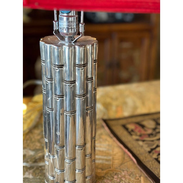 Red hot pair of faux bamboo, regency style, high-quality chrome table lamps with cherry red shades. 12” to top of base 22”...