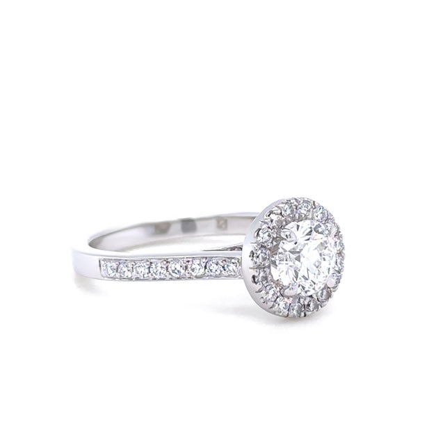 This elegant bridal set features a cast platinum engagement ring with a central 0.80ct round brilliant-cut diamond of H...