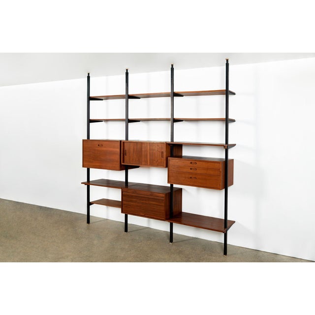 This exceptional early-production vintage mid-century modern three-bay OMNI modular wall unit shelving system was...
