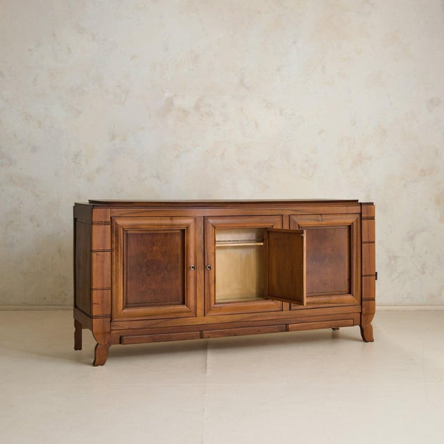 A French sideboard from the 1950s, designed with a concealed bar integrated within. Broad and grounded, the piece carries...