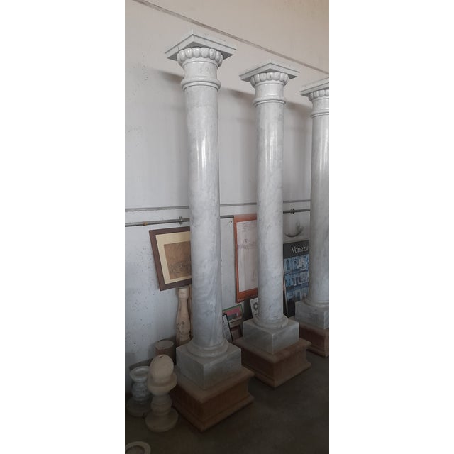 doric style columns in polished carrara marble with capital with the same florentine lily, made in italy. Stamped by Maker