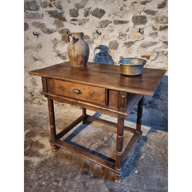 This rustic French oak table originates from the Auvergne region and dates from the late 18th to early 19th century....