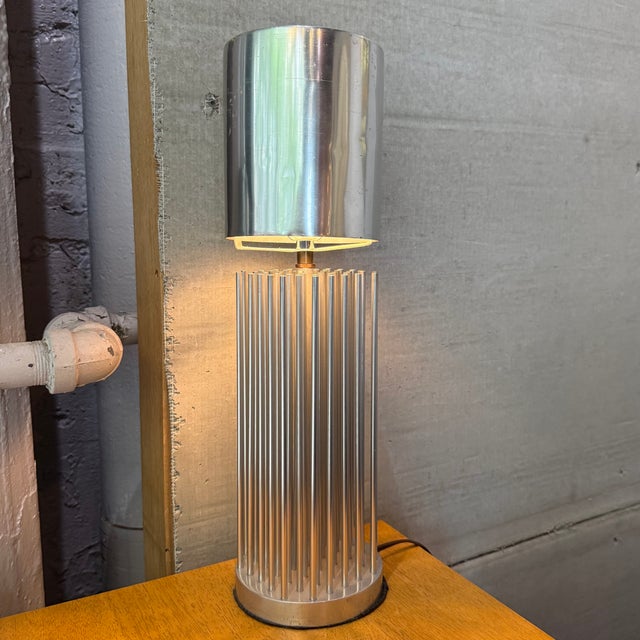 This small Modernist table lamp circa the 1980s features an interesting, architectural aluminum cylinder base constructed...