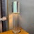 This small Modernist table lamp circa the 1980s features an interesting, architectural aluminum cylinder base constructed...