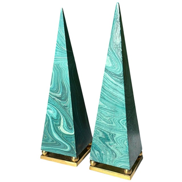 Striking pair of vintage decorative obelisks featuring a dramatic faux malachite finish in shades of turquoise and green....