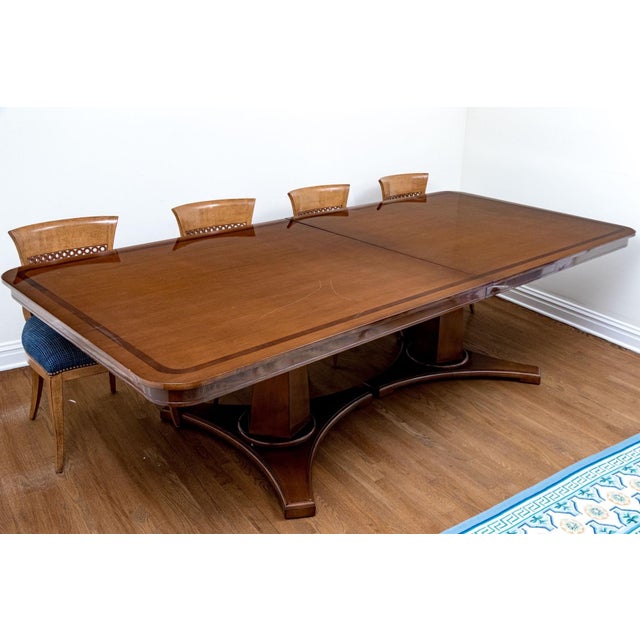 A stunning Hollywood Regency style Nancy Corzine double pedestal extension dining table with a banded top and a pair of...