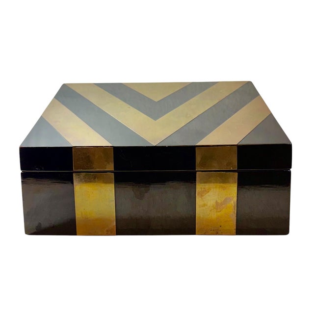 A stylish American black lacquer decorative box from the early 1970s featuring finely executed brass inlay characteristic...