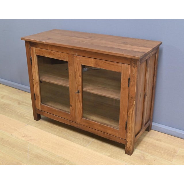 Add a touch of authenticity to your home with this solid teak display cabinet, crafted in India in the early 20th century....