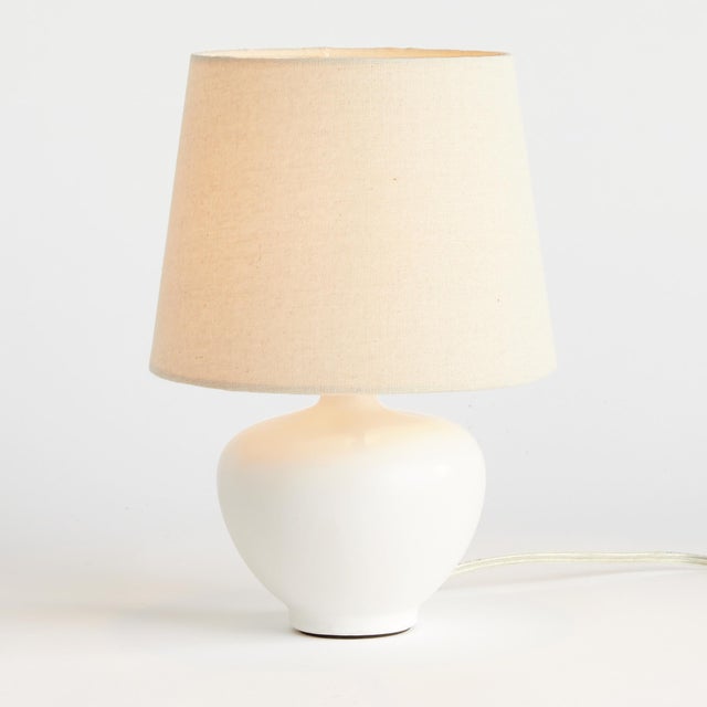 This sweet little ceramic lamp is a modern take on a classic silhouette. The wellscaled shade and matte finish complete...