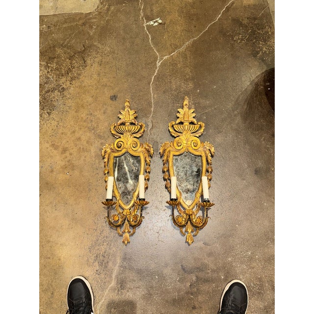 This product is a pair of Italian antique giltwood wall sconces, adding a touch of elegance and sophistication to any...
