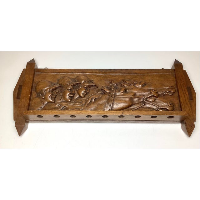 Fantastic carved oak wall rack featuring a dynamic horse racing scene with three jockeys and galloping horses in deep...