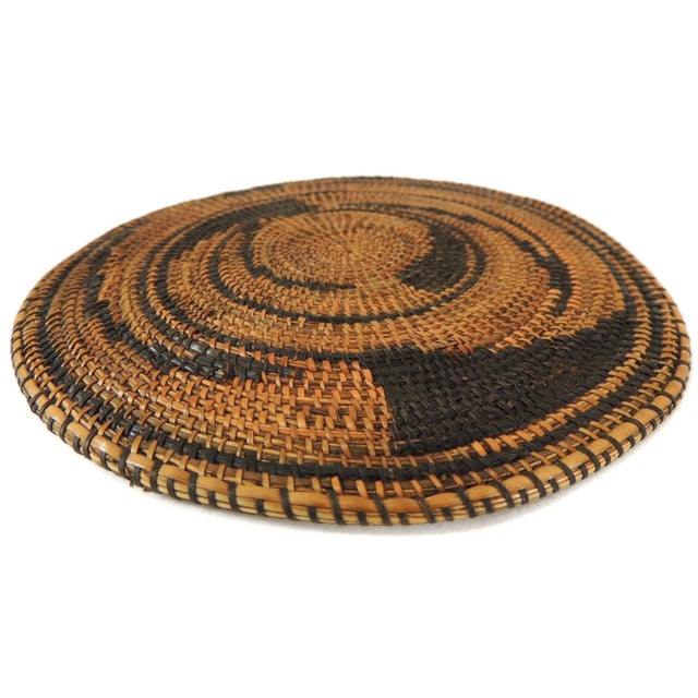 Flat baskets/lids such as this are among the most exquisite artworks made by the Tutsi or by people of other ethnic...