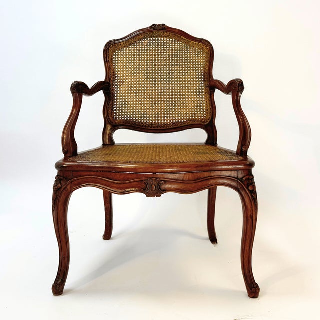 This magnificent louis xv armchair from the second half of the 18th century embodies french elegance and masterful...