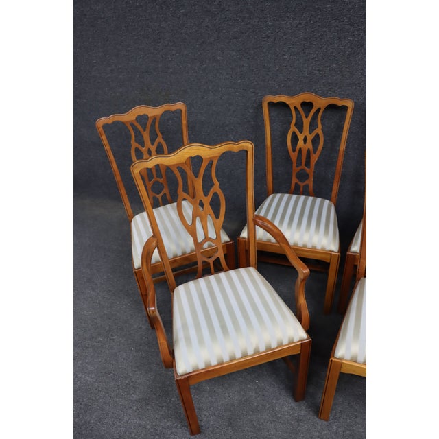 Set of ten Harden cherry dining chairs in a Chippendale-inspired style featuring pierced splat backs with an open fretwork...