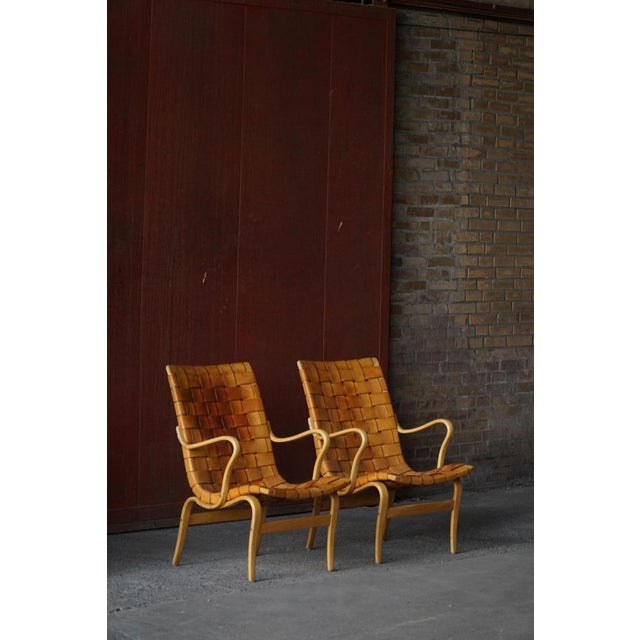 A pair of iconic "Eva" lounge chairs designed by Bruno Mathsson and produced by Karl Mathsson, Sweden. First introduced in...